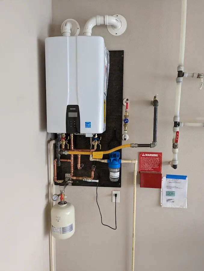 Professional plumber installing copper piping in a Hemet home